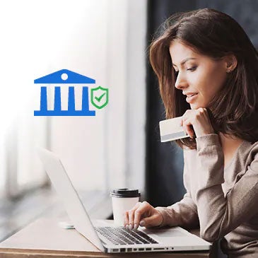 Woman on laptop holding credit card